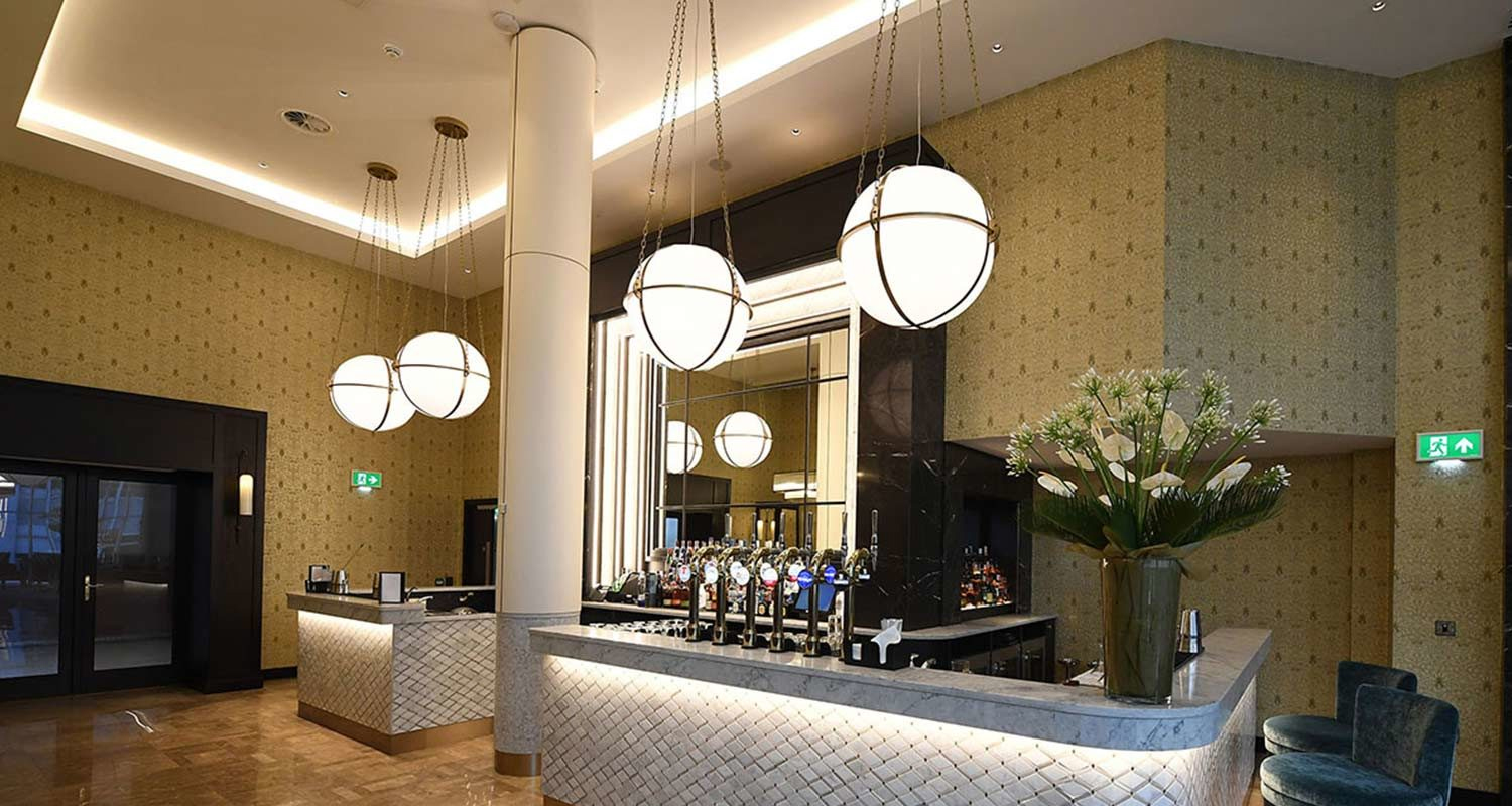 Globe Pendant Lights suspended with metal chains at the Lobby Area of the the Grand Central Hotel Belfast