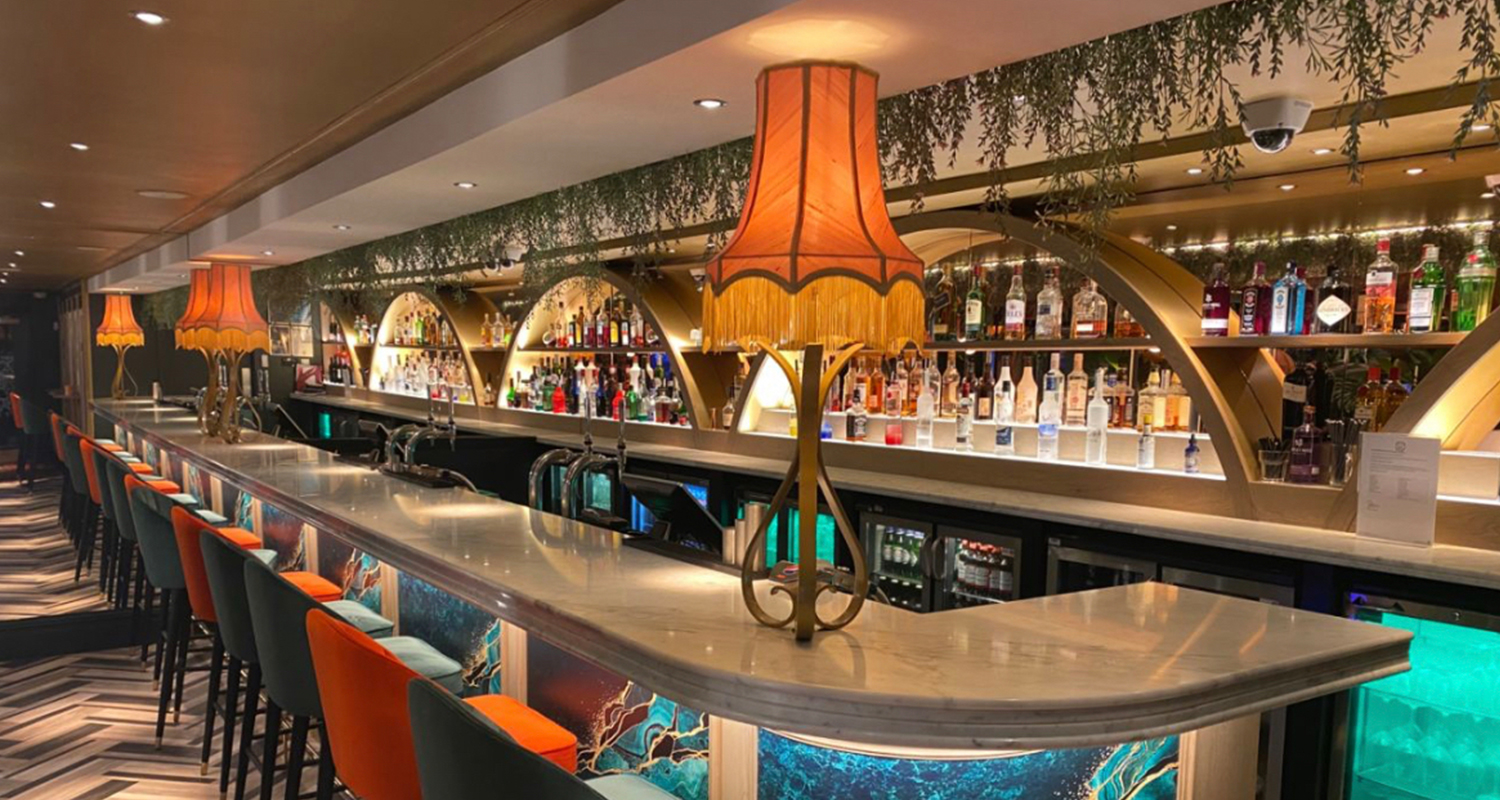 Tall Bowed Empire Blush Pink Silk Table Lampshades with gold fringe at the casino bar