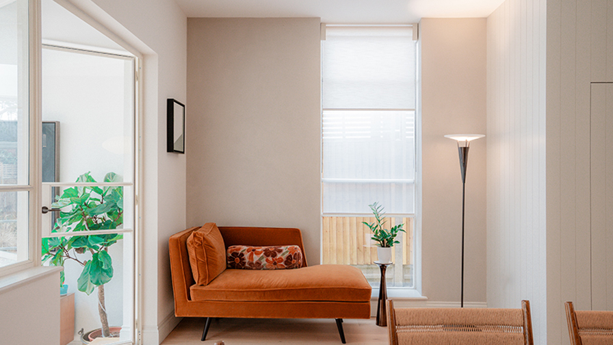Modern lounge area with VENESTRE made-to-measure V01 Double roller blinds, fitted to tall windows for privacy and light diffusion. The custom window treatments enhance the contemporary design, delivering a seamless and elegant finish to the space.