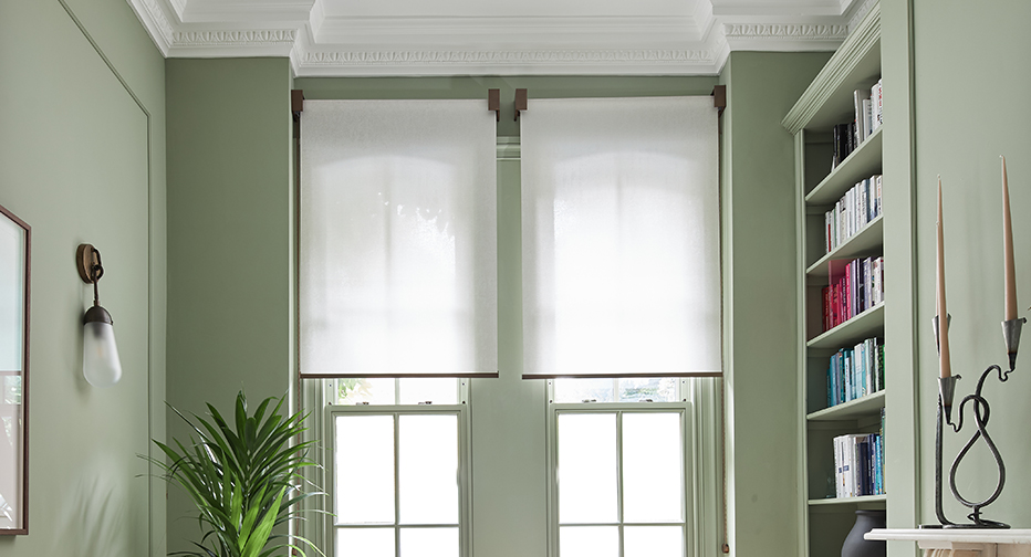 Contemporary home office with made-to-measure VENSTRE elegant roller blinds, providing privacy and natural light. Features custom window treatments, minimalist furniture, and luxury interior design.