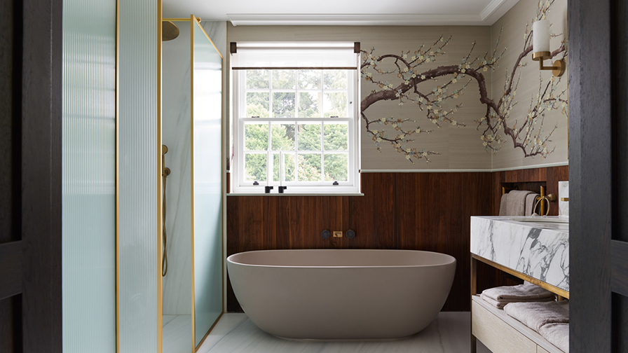Modern bathroom featuring VENESTRE made-to-measure roller blind in a sheer fabric, installed above a freestanding bathtub. 
