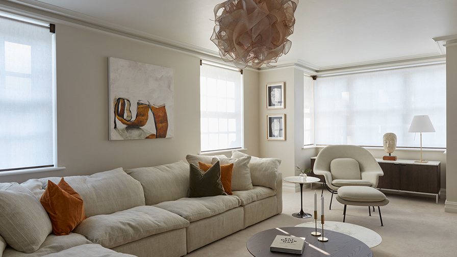 Modern living room featuring VENESTRE motorised roller blinds in a sheer fabric, fitted to multiple windows. 