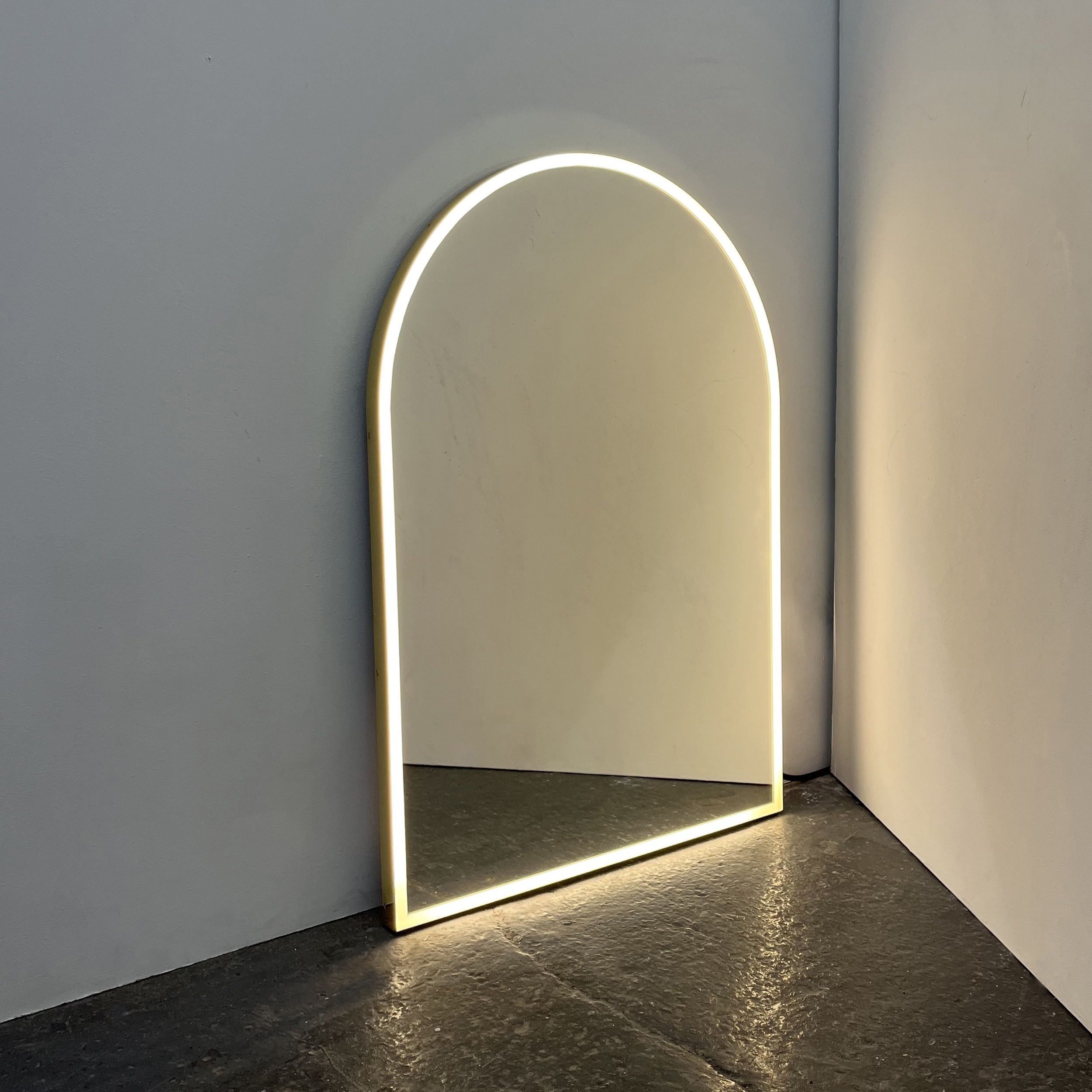 Front Illuminated Arched Contemporary Mirror with a Brass Frame