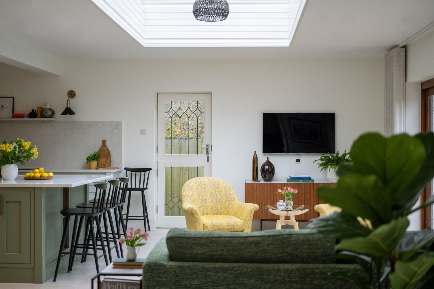 Yellow accent chairs with TV space in kitchen