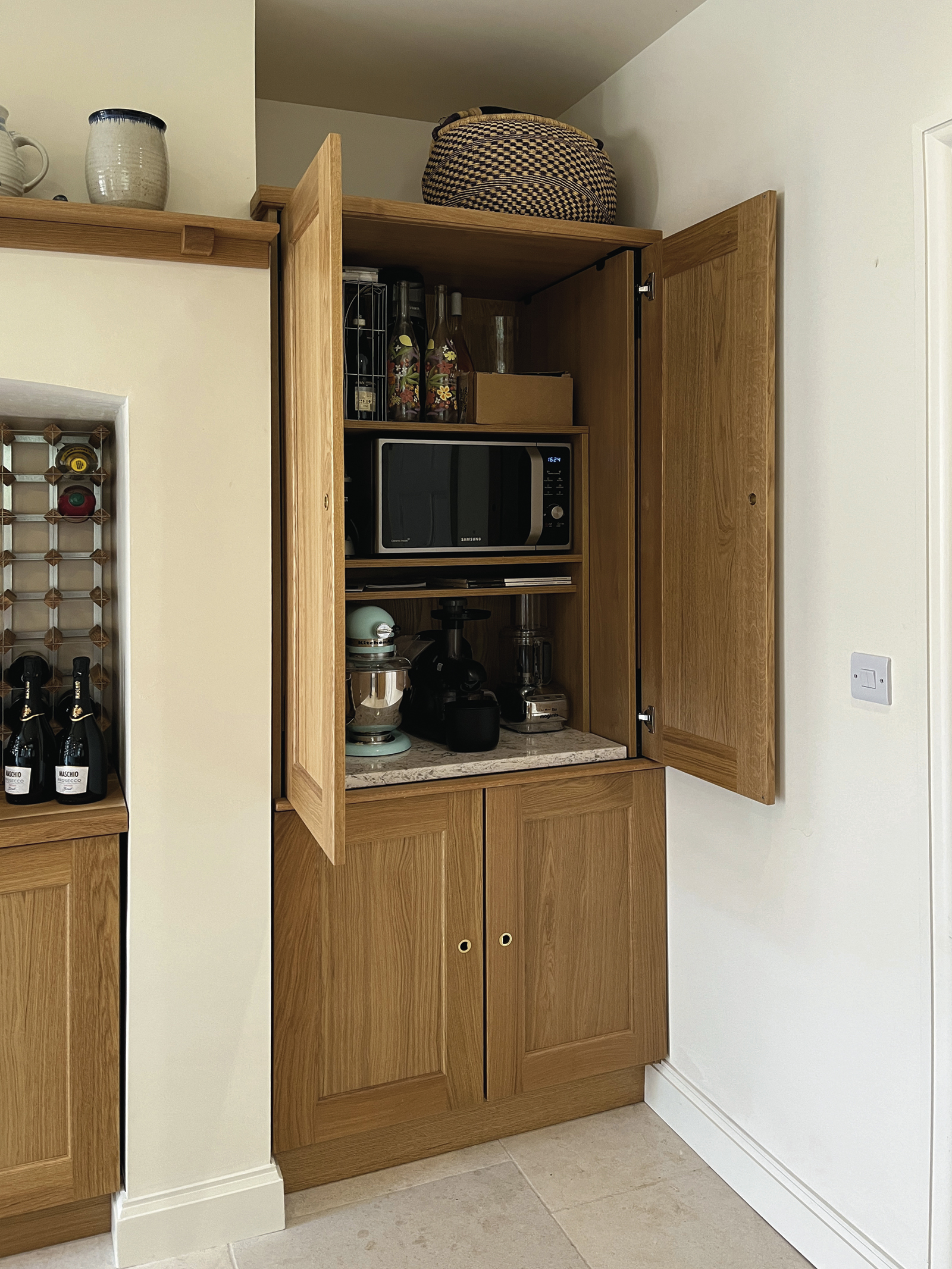 Microwave cabinet with pocket doors