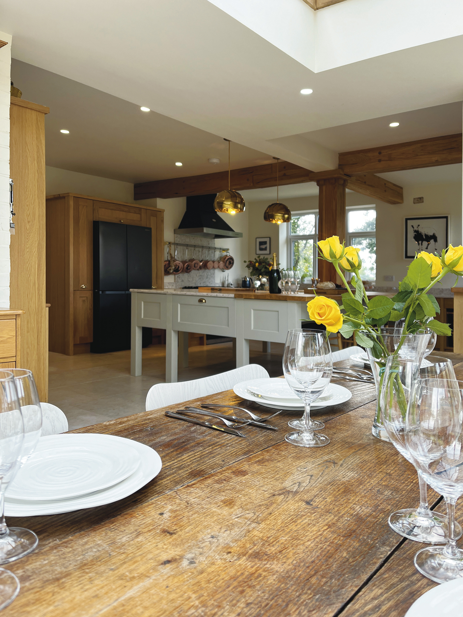 Prep island on legs painted in Taupe with surrounding cabinets in solid oak.