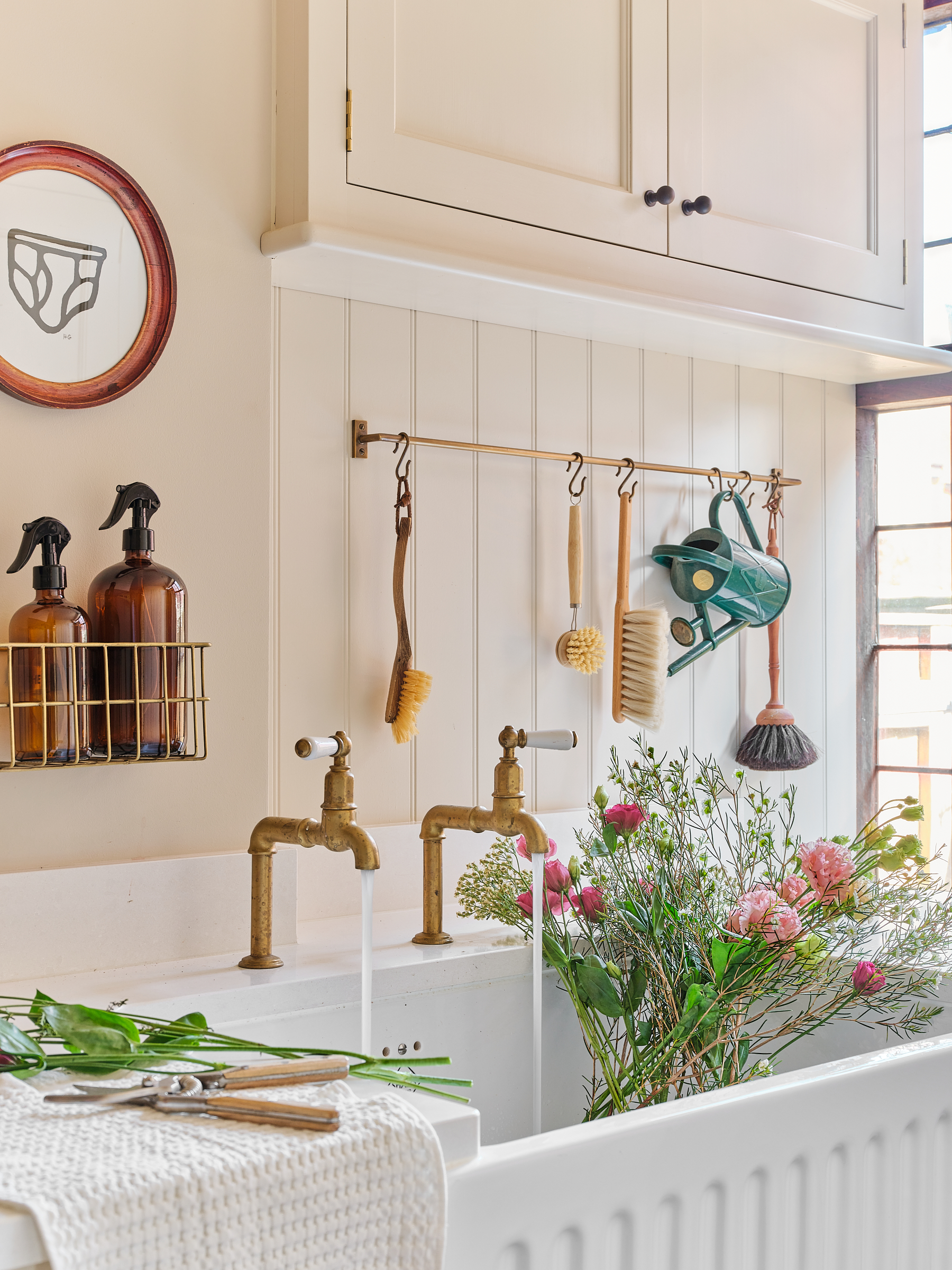 Shaker style cabinets in laundry utility with Perrin and Powe brass bib taps and butlers sink