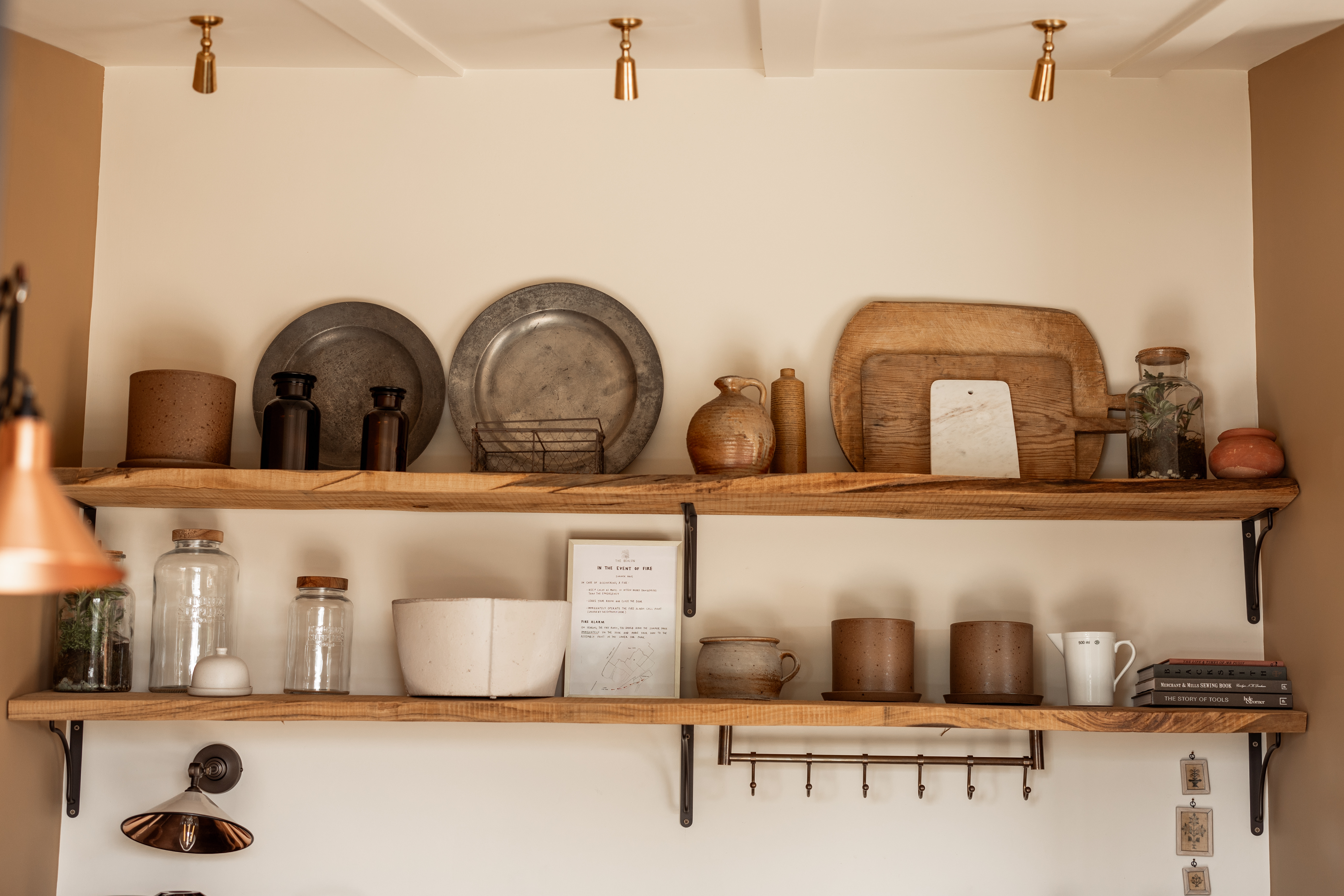 Open oak kitchen shelves with rust antique accents and styling