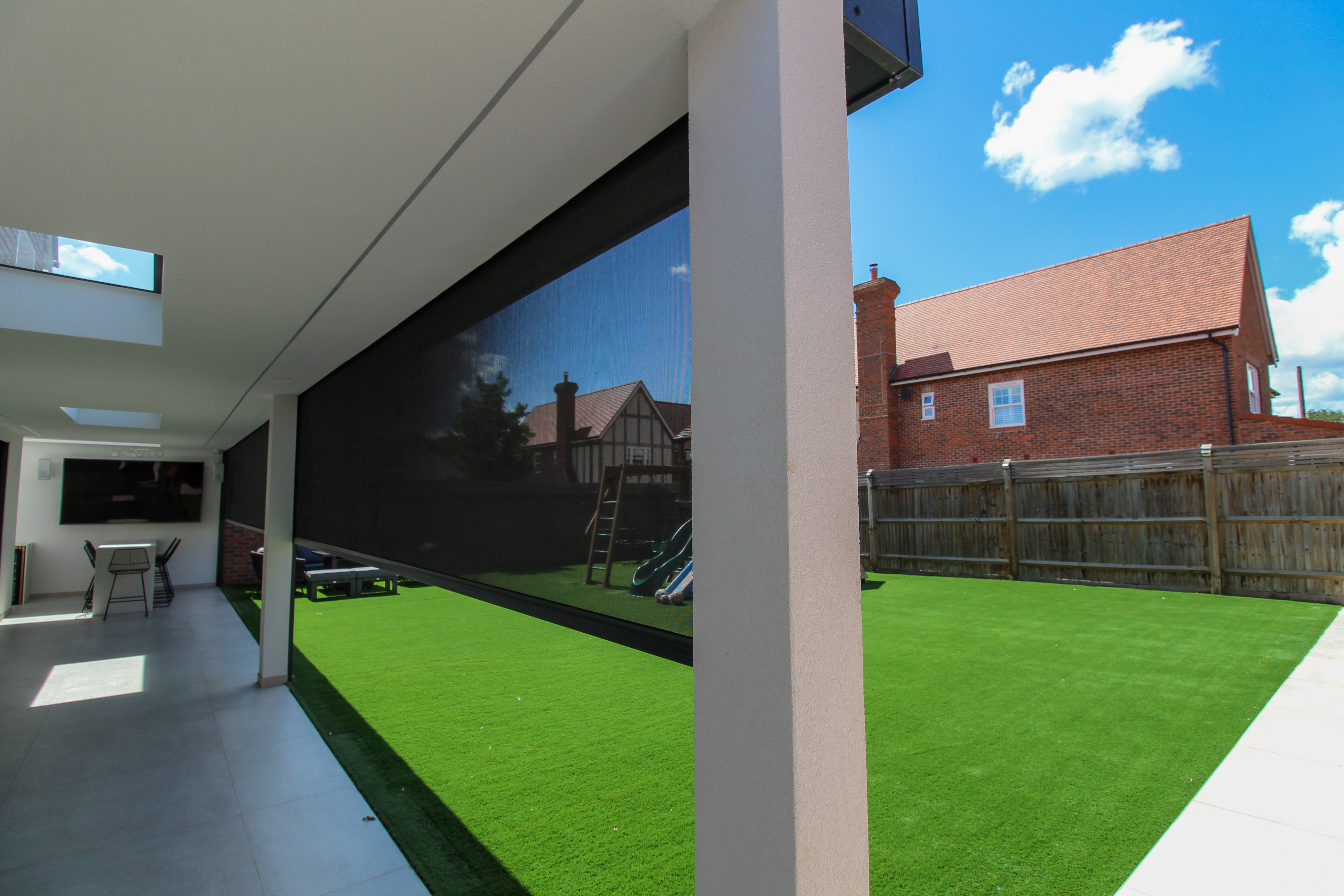 Solar screens deployed on a contemporary home, offering a balance of light management and insect protection