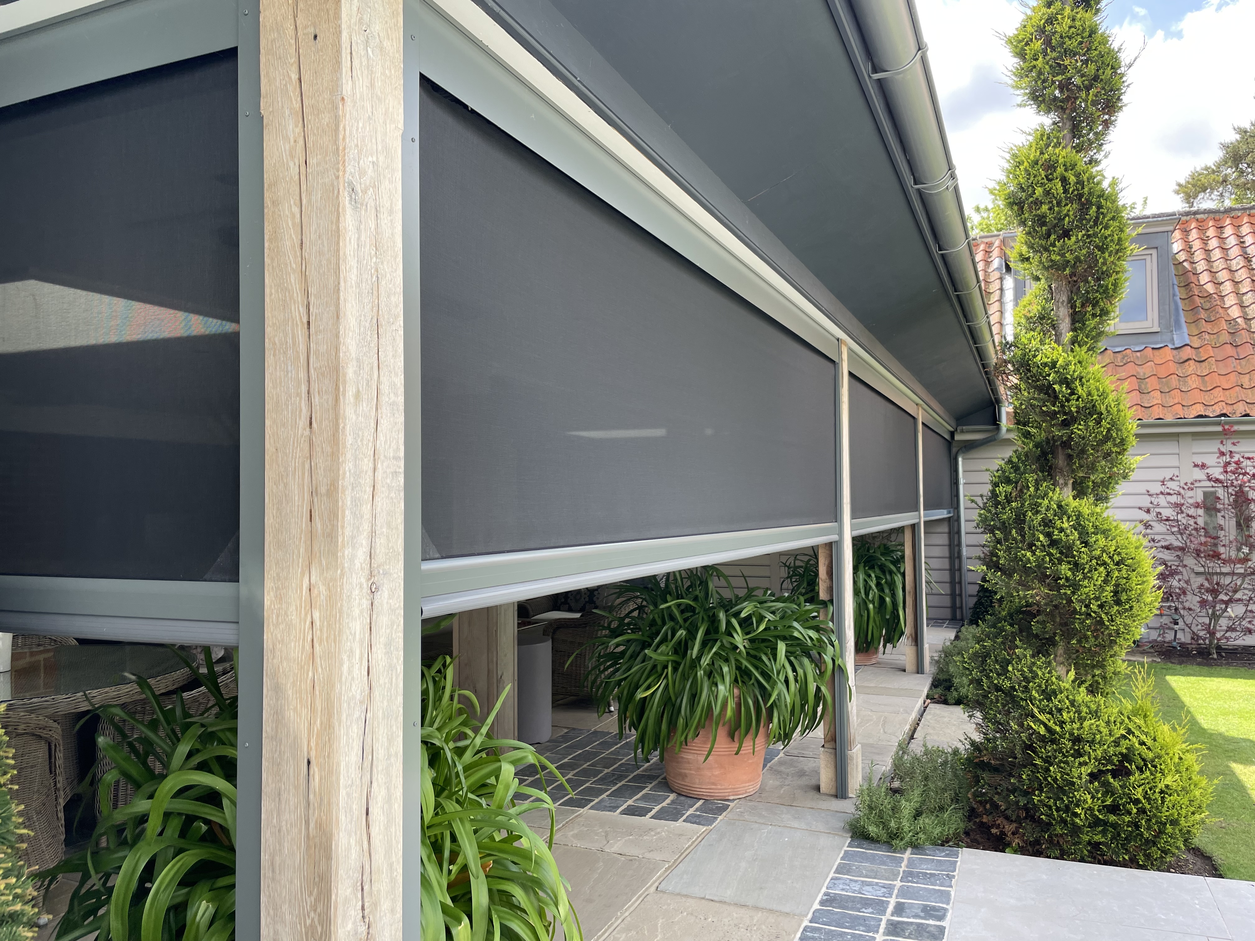 Automated fly screens around a covered seating area