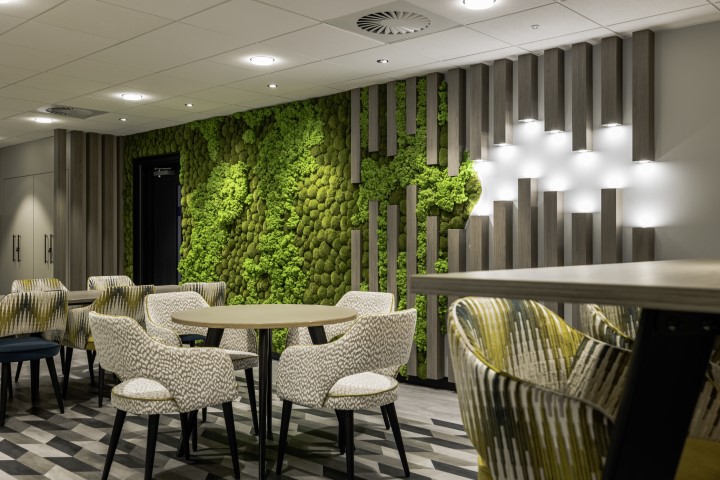 Detail shot focussing on upholstery and moss wall design details