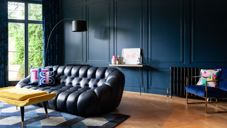 Lion and Unicorn interior design  dark sofa and blue walls 