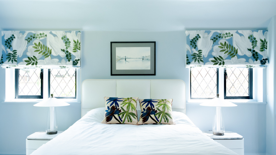 Home renovation white bedroom with bright cushions 