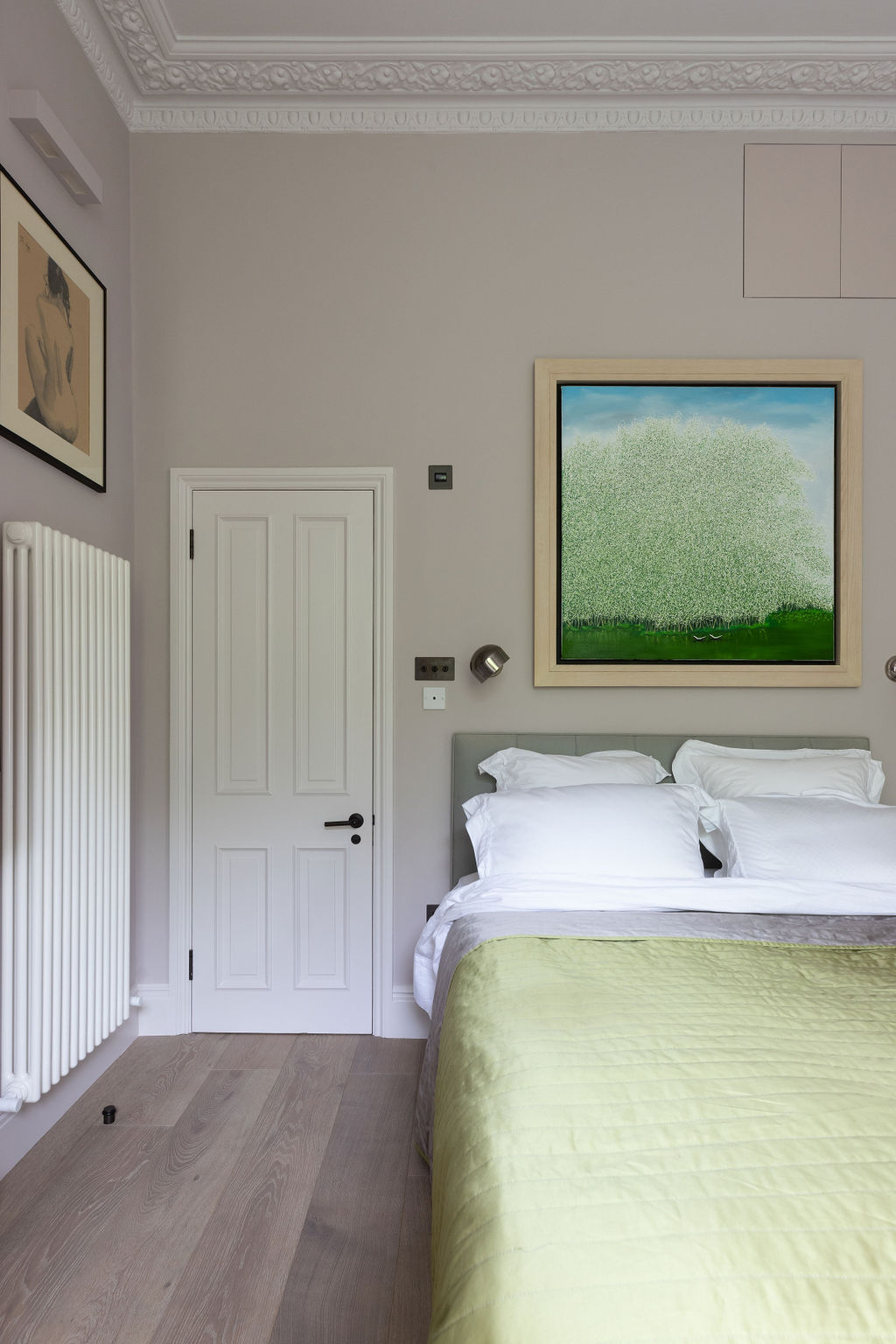 traditional mouldings with artworks on the wall and luxurious bed