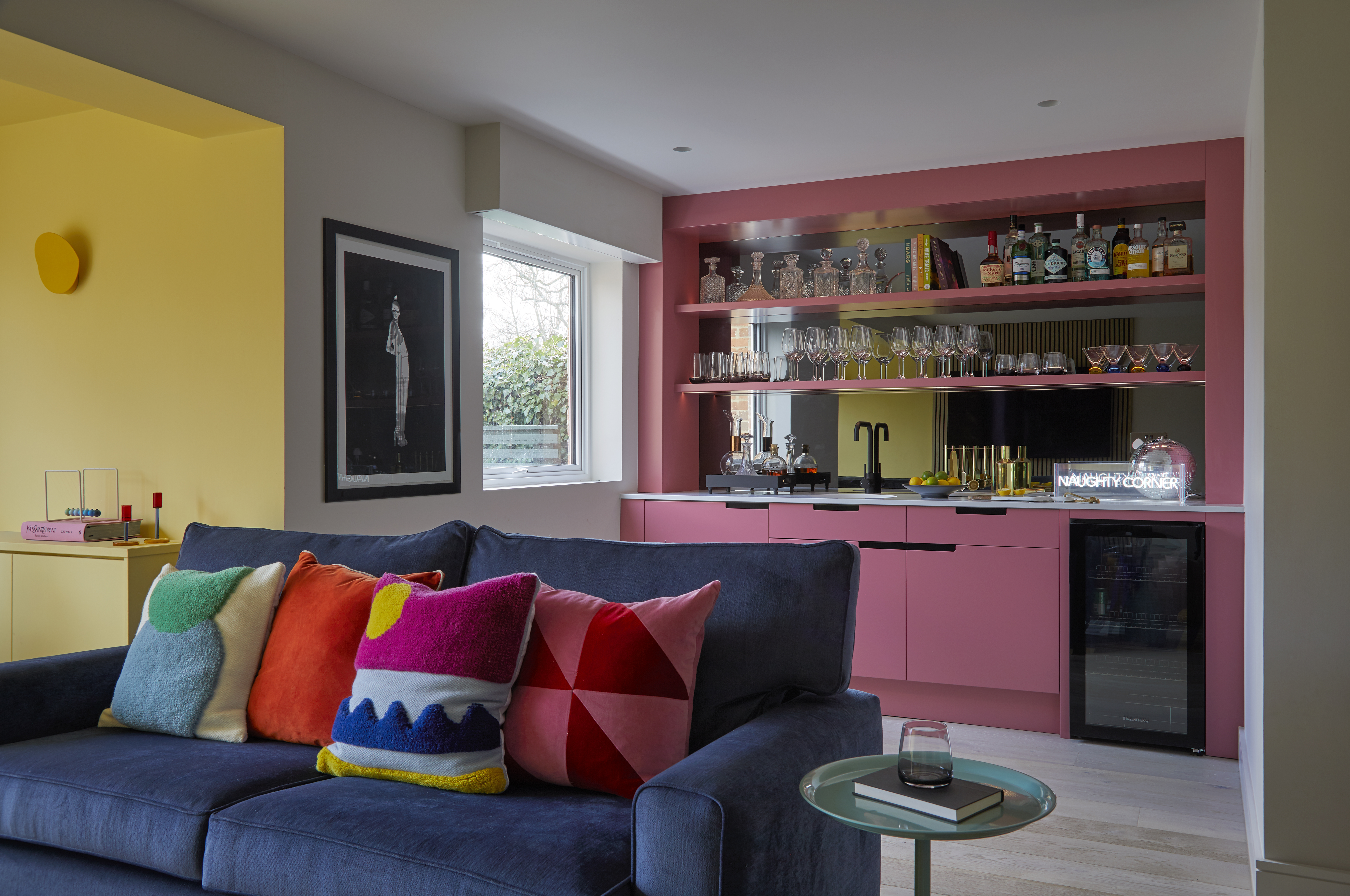 A playful snug area completed by a bespoke bar, perfect for hosting friends and family