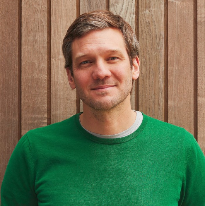 smiling man in a green jumper