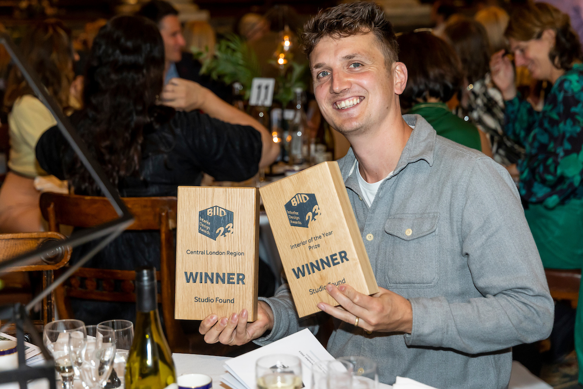 smiling winner holding their award