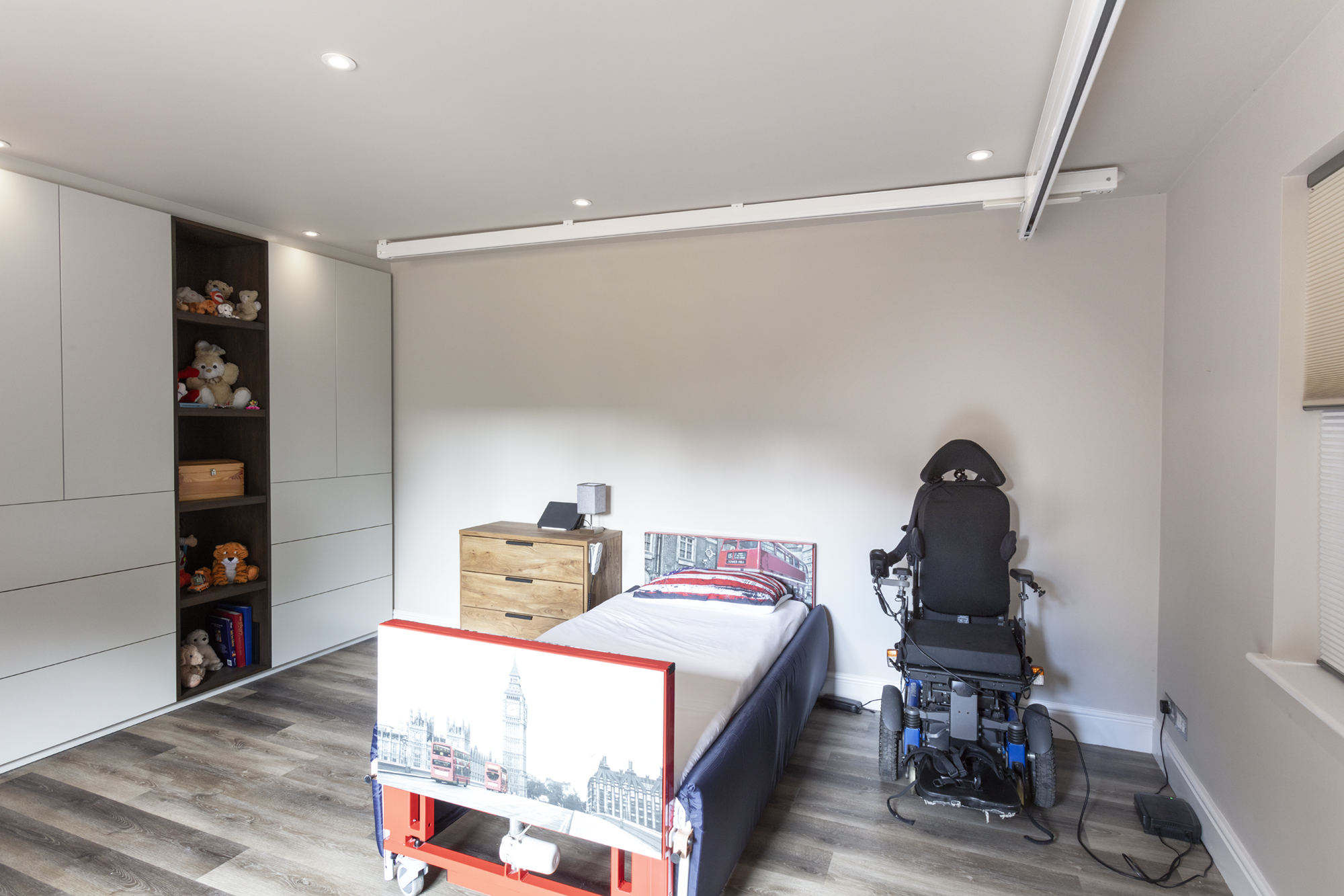 Wheelchair accessible child's bedroom with with storage and hoist system