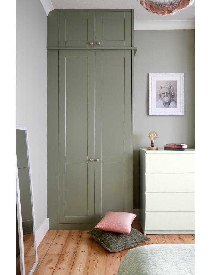 tall green wardrobe in a bedroom