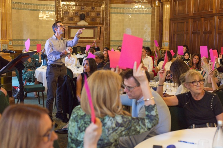 People holding up voting slips