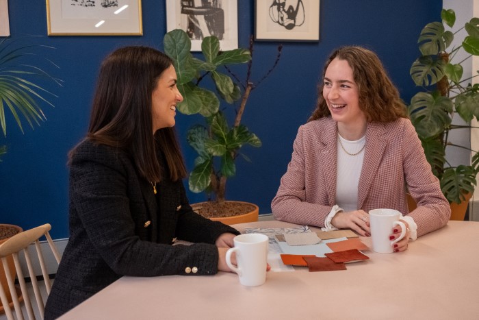 Two people at a table with coffee and swatches