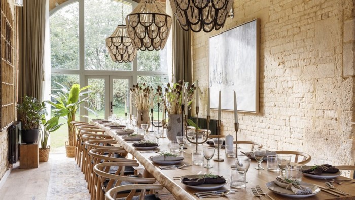 very long dining table with place settings and candles