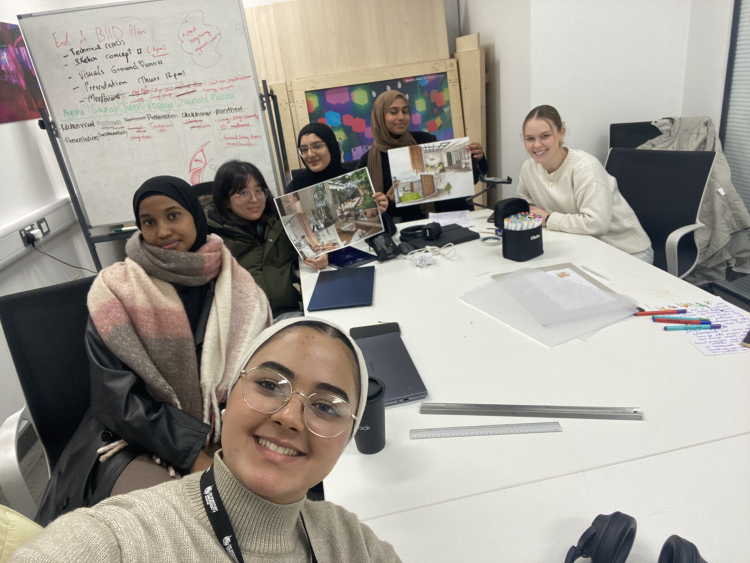 selfie of 6 people round a large table