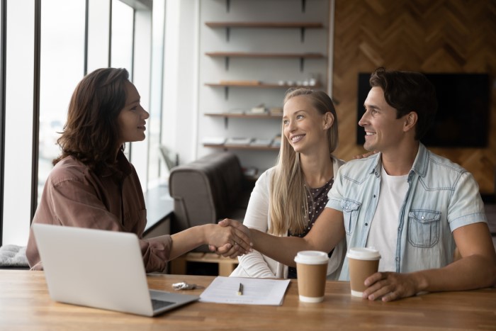 designer shaking hands with clients.