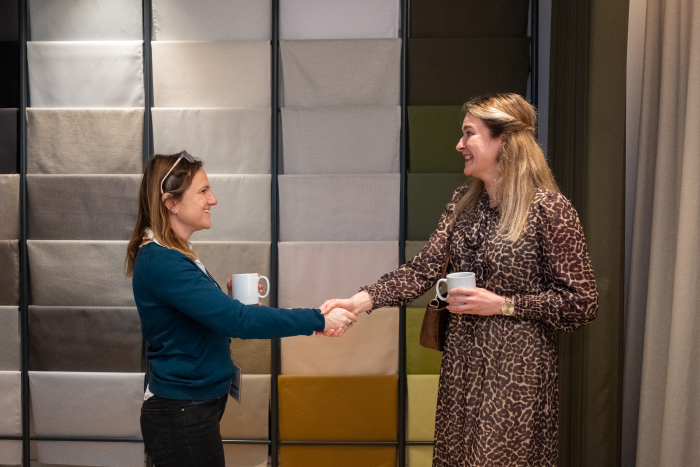 two women shaking hands