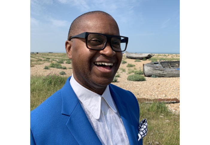 man in a blue jacket and glasses