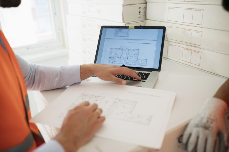 Surveyor looking at plans