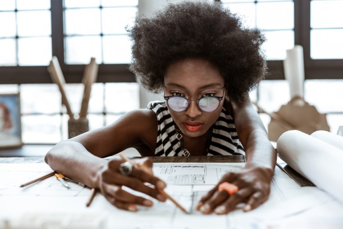 woman looking at and amending plans