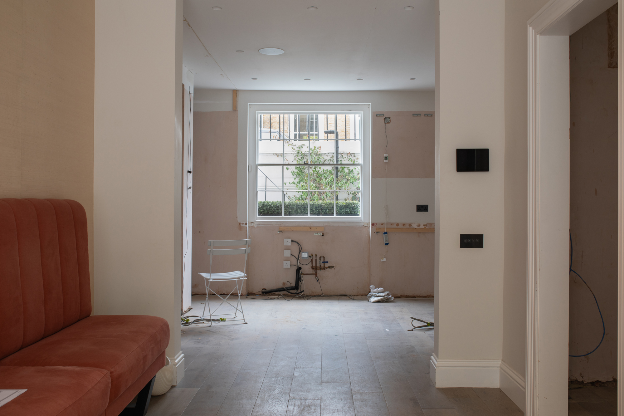 Reconfigured ground floor of a Chelsea townhouse during a major residential refurbishment, showing interior architecture planning for a full turnkey luxury renovation.