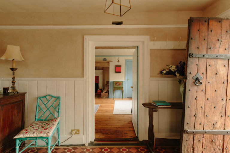 Hallway with old wooden front door 