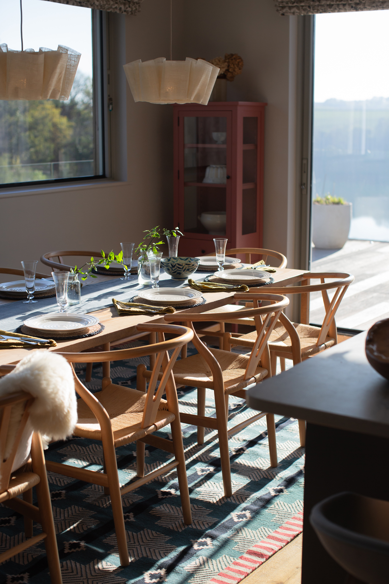Fully furnished dining area within a contemporary riverside new build, designed as part of a high-end, turnkey interior architecture project with bespoke furniture, lighting and styling throughout.