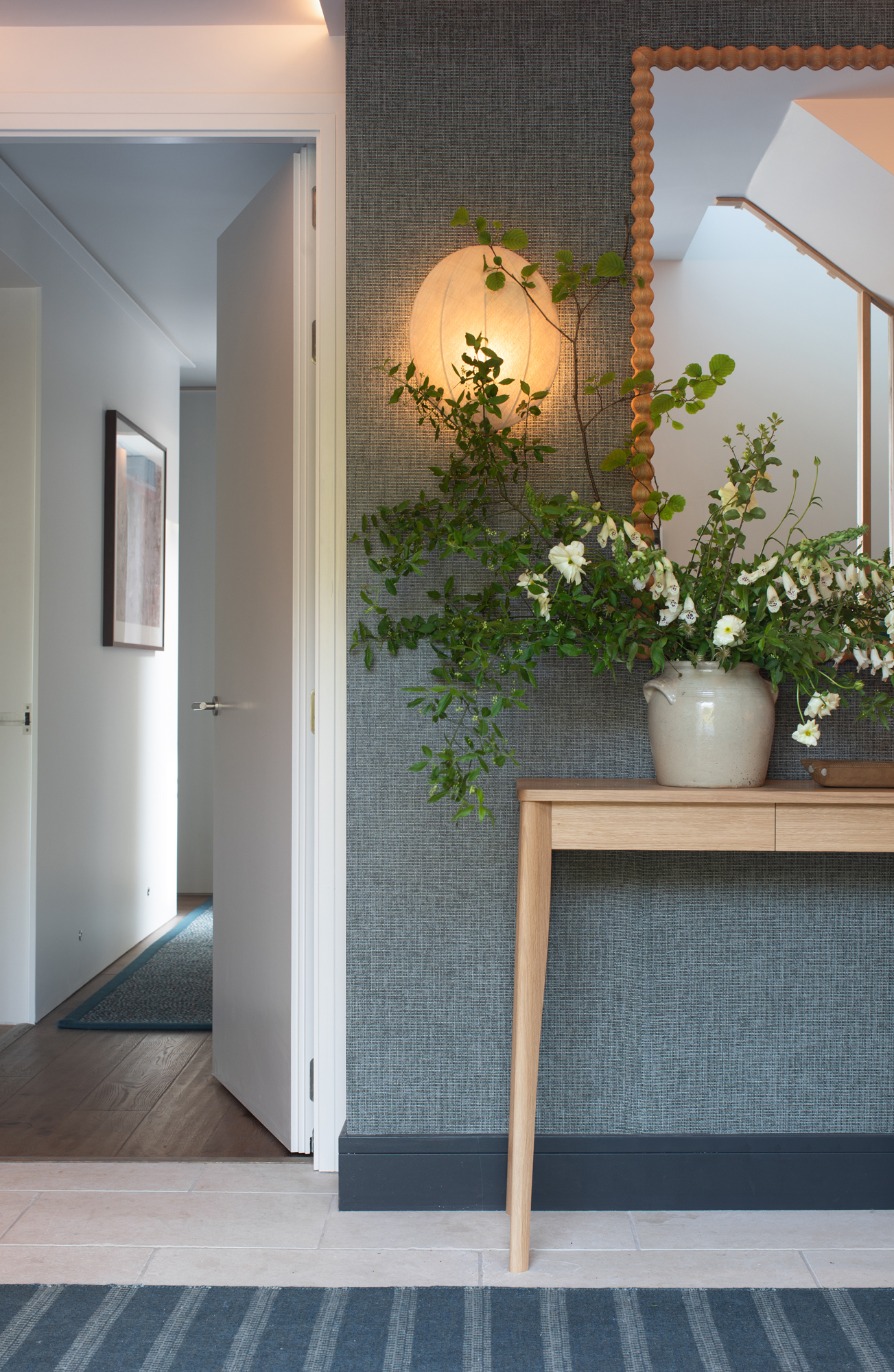 Refined reception space within a contemporary riverside new build, showcasing tailored interior architecture, considered lighting and fully furnished detailing as part of a high-end turnkey project.