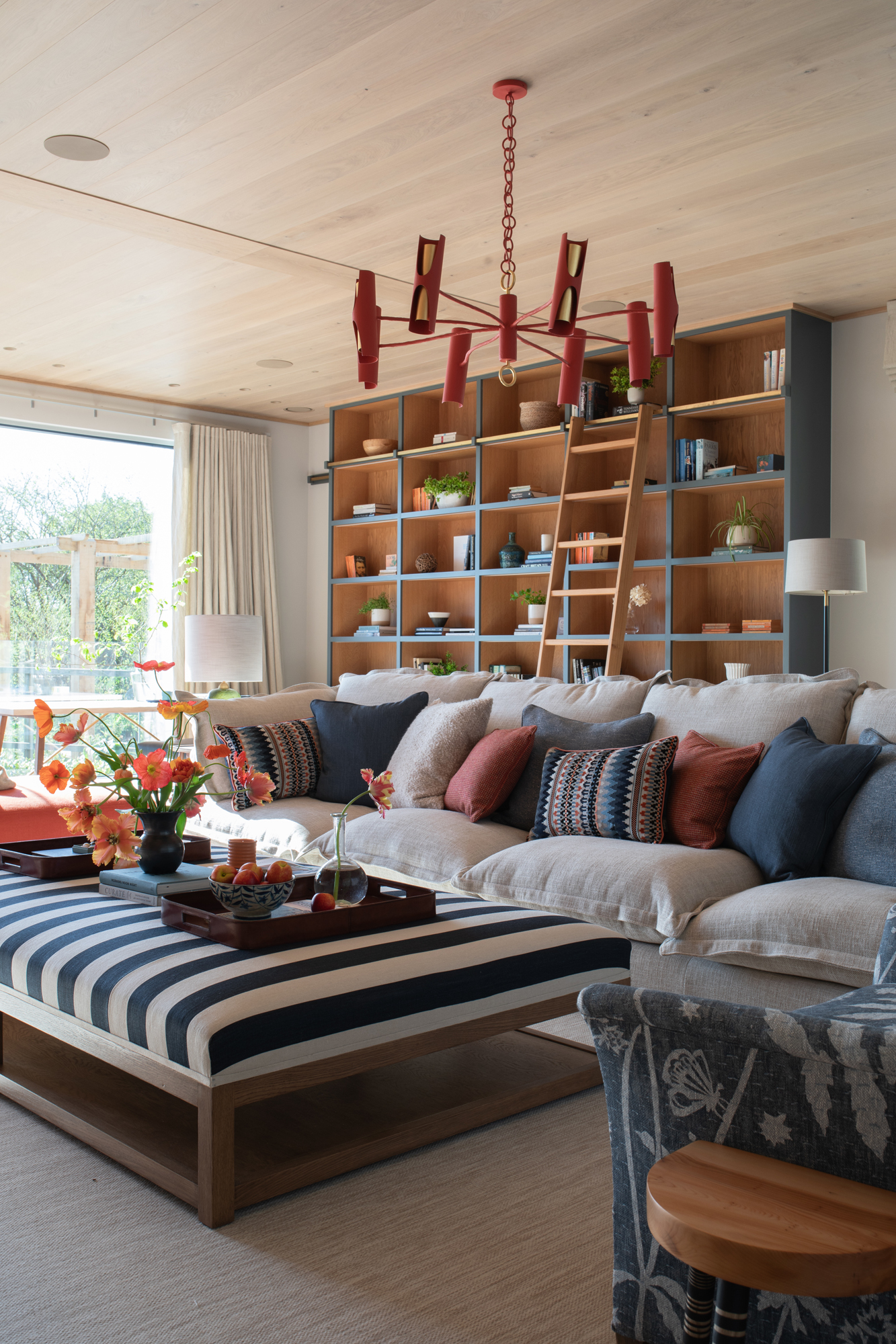 Spacious reception room within a contemporary riverside new build, fully furnished and styled as part of a high-end, turnkey interior architecture project for modern family living and entertaining.