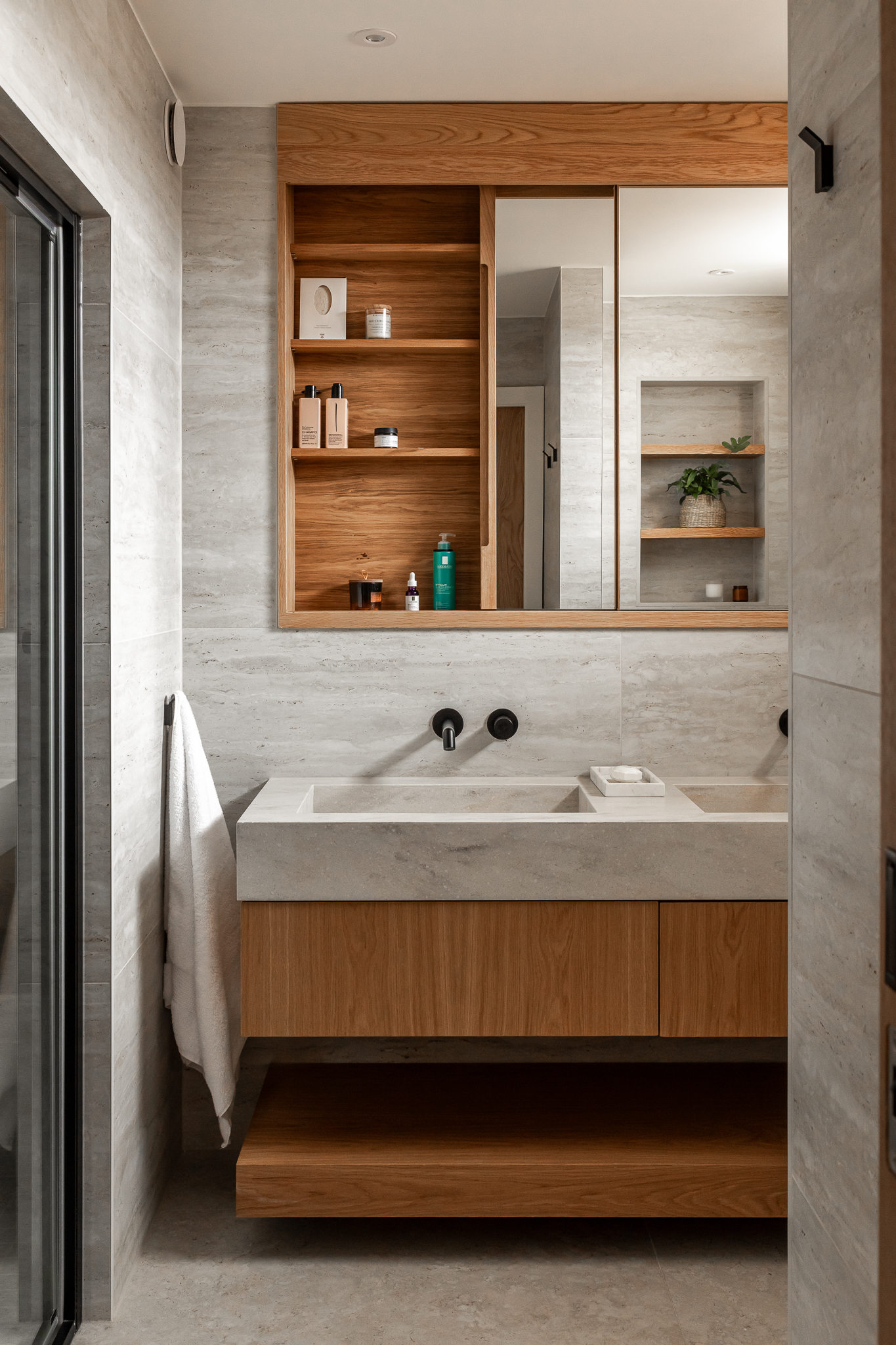 Bespoke bathroom oak cabinetry including concealed wall cabinet and shelving 