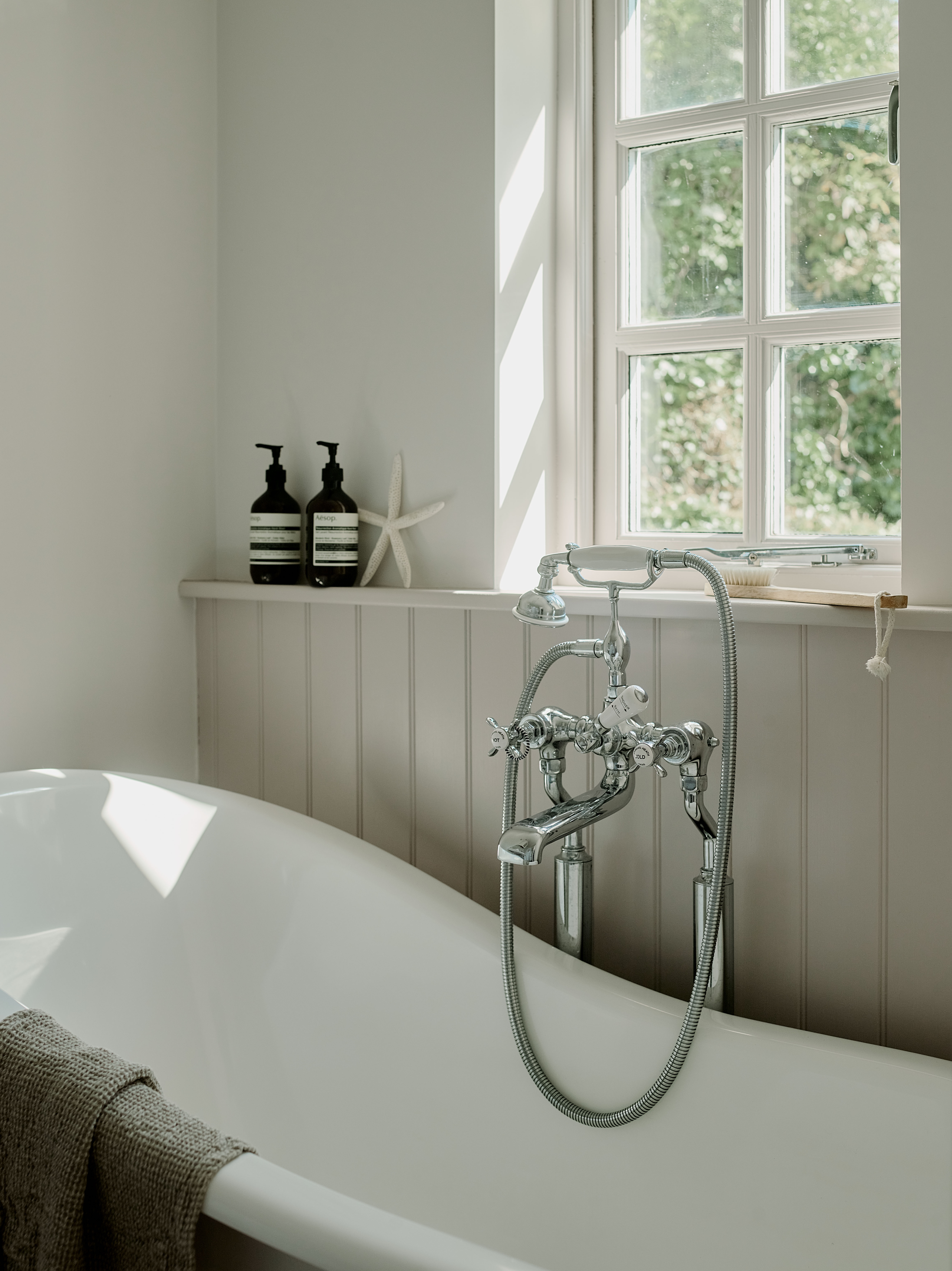 Bathroom in a remote West Cornwall cottage featuring a freestanding bath, traditional fittings and soft natural light, redesigned as part of a full interior architecture project.