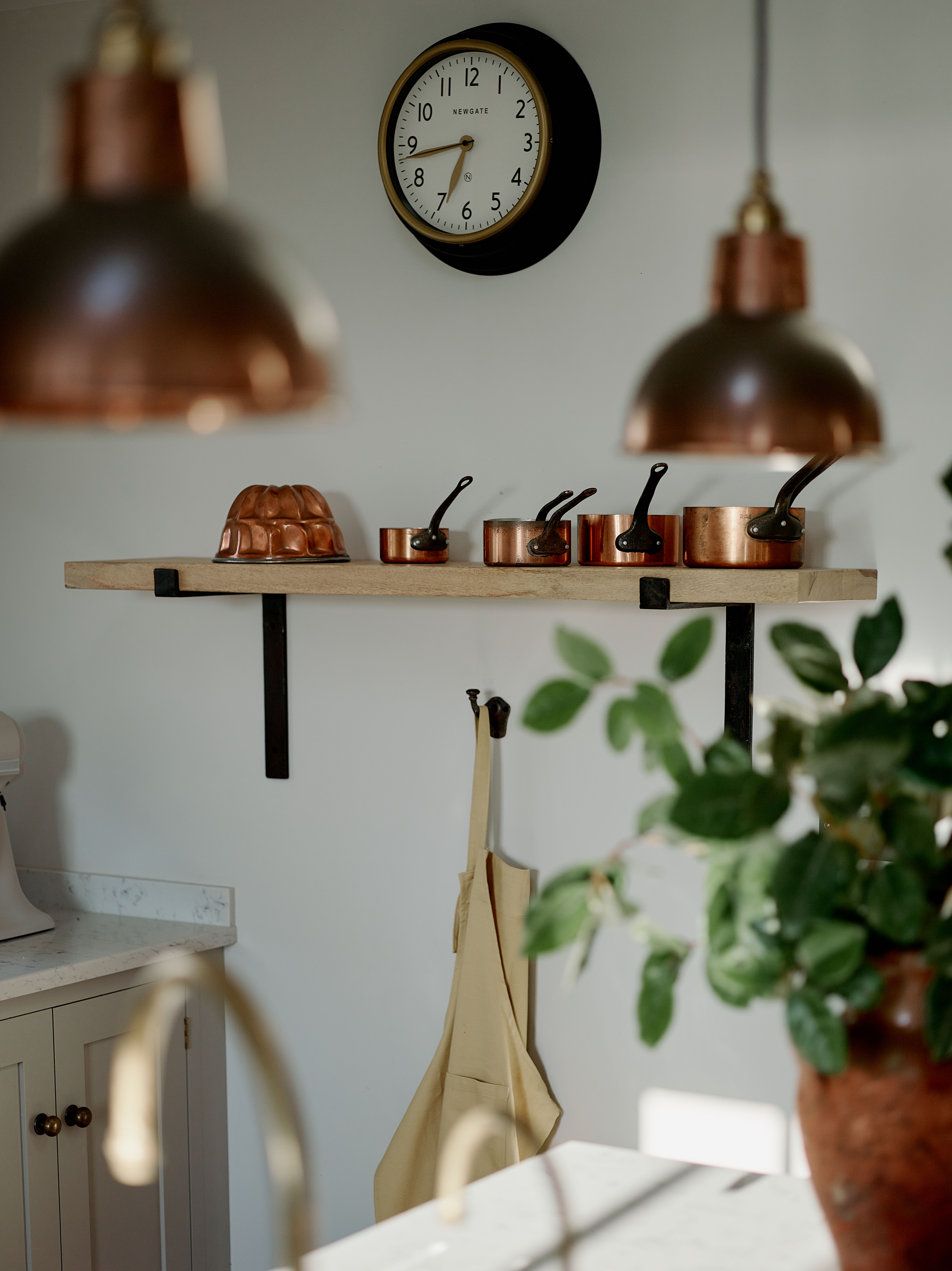 Kitchen detail in a remote West Cornwall cottage featuring open shelving, copper cookware and simple finishes, part of a full interior reconfiguration and furnishing project.