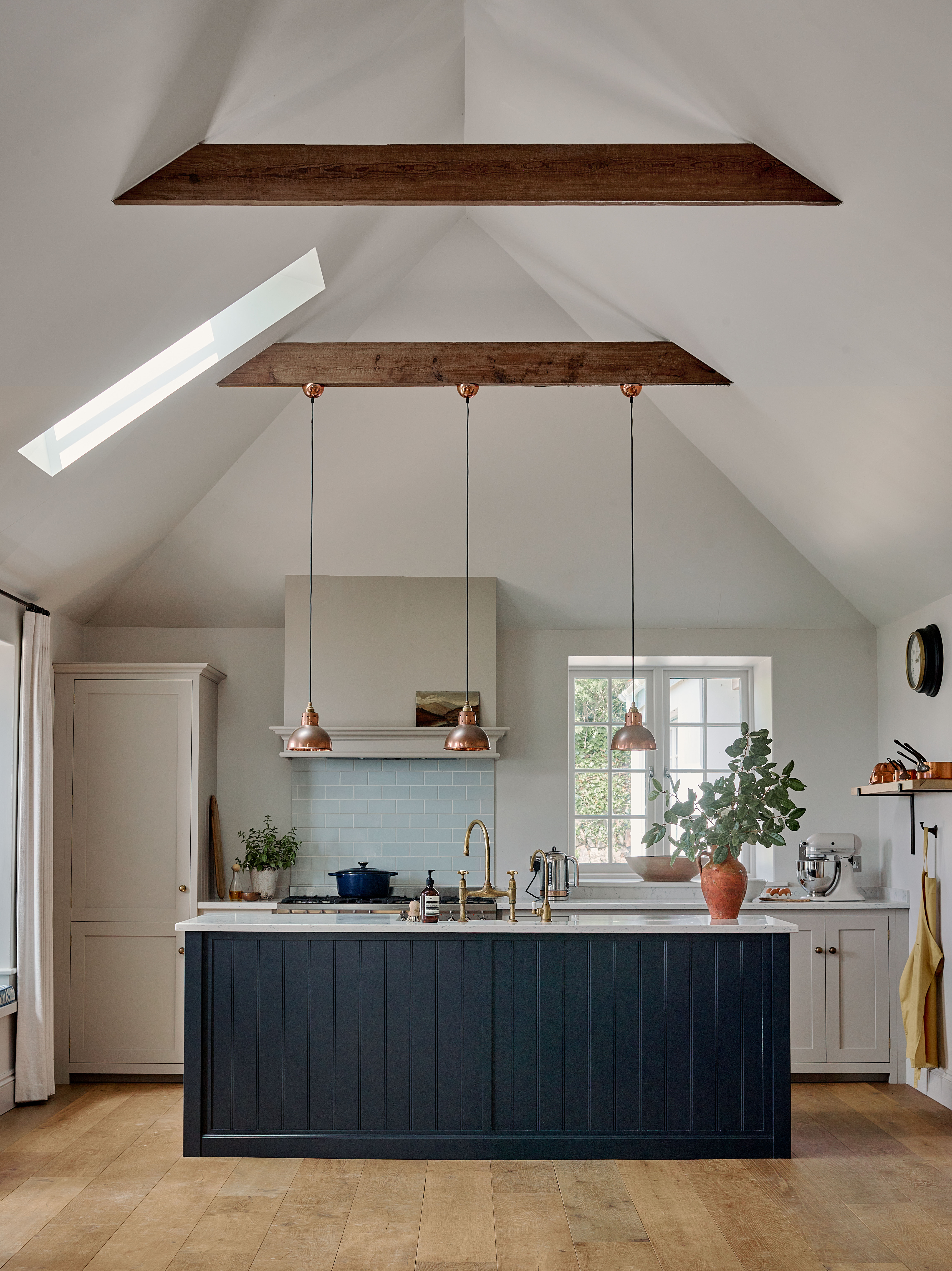 Vaulted kitchen interior in a remote West Cornwall cottage, reconfigured into an open-plan family living area with exposed beams, bespoke cabinetry and coastal light.