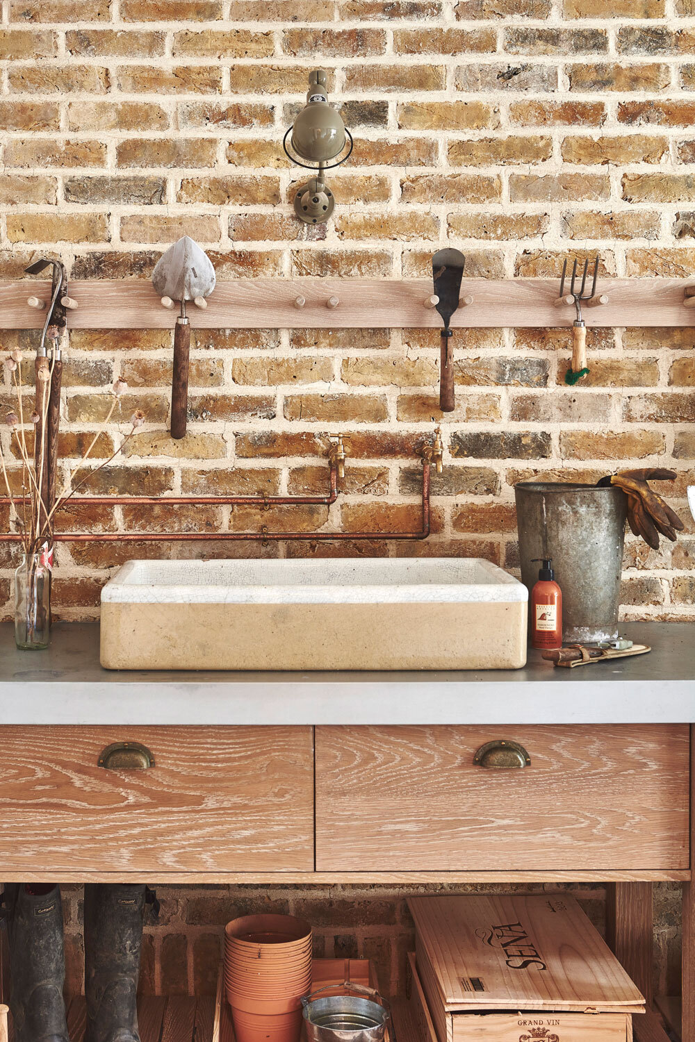 Sink infront of brick wall