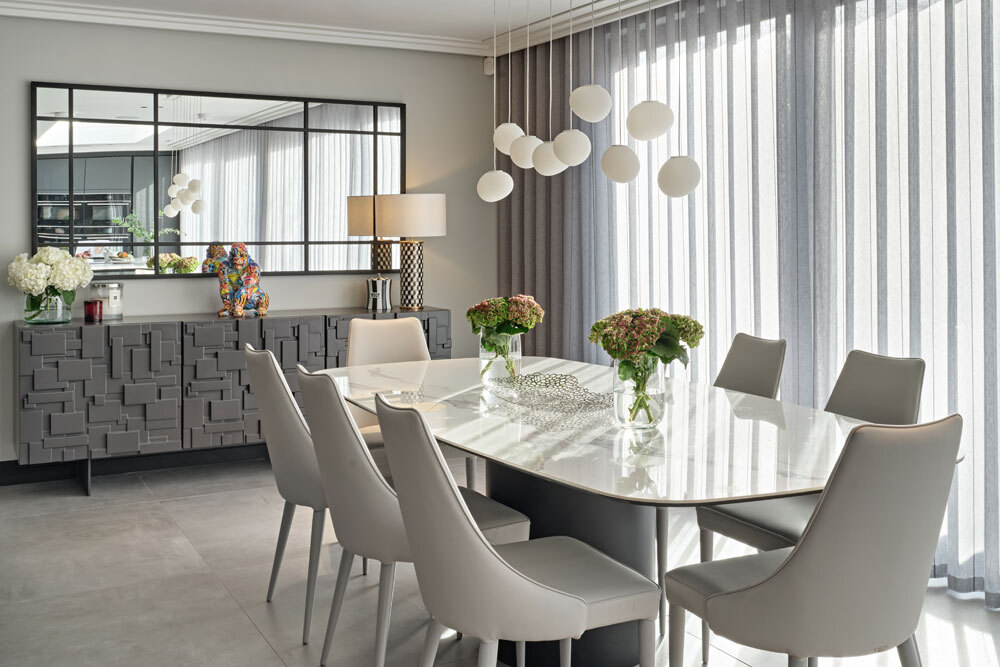 Dining area with pale chairs