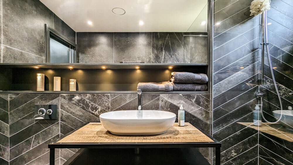 Bathroom with dark tiles