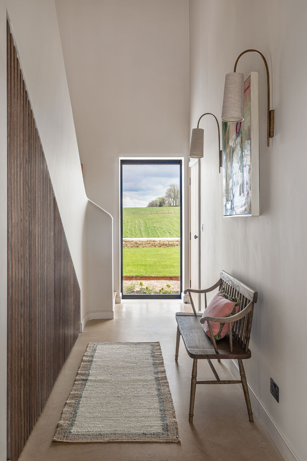 Hallway with bench and small rug