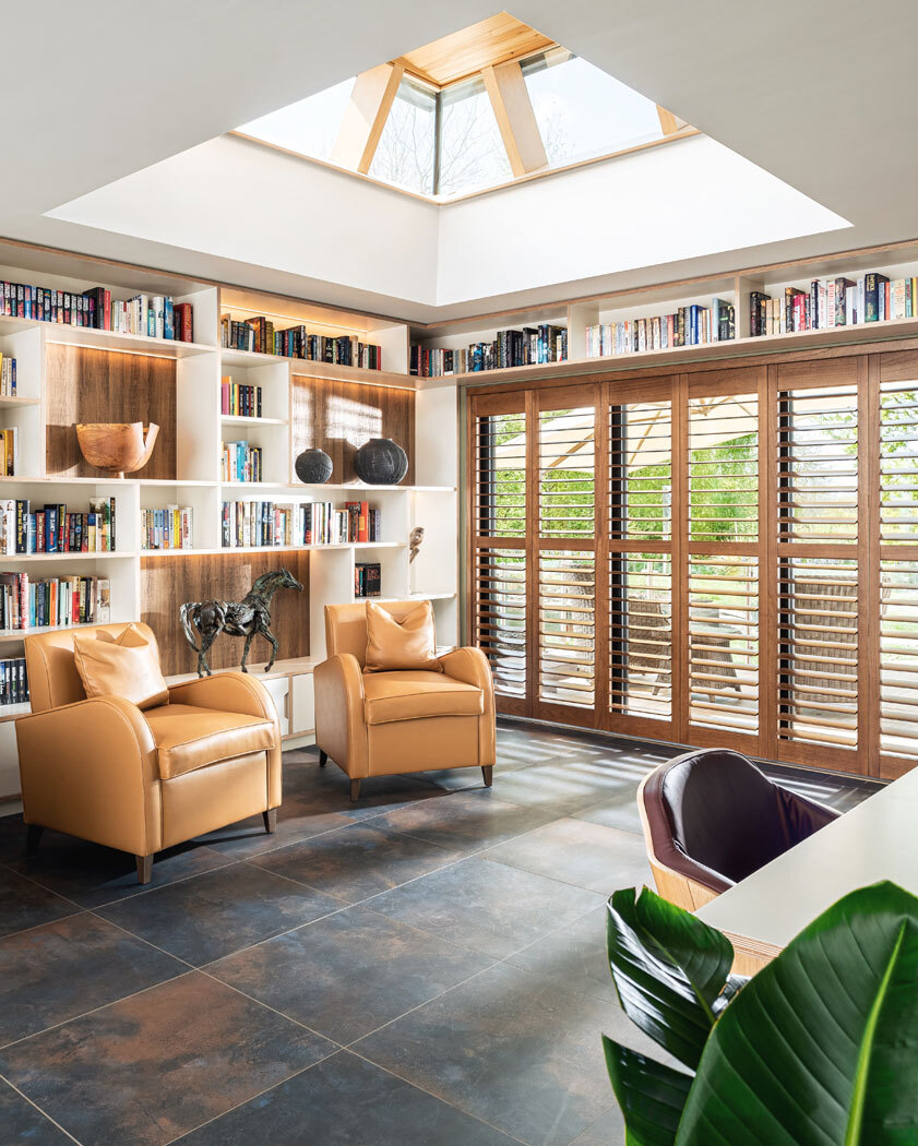 Living space with two armchairs and large windows