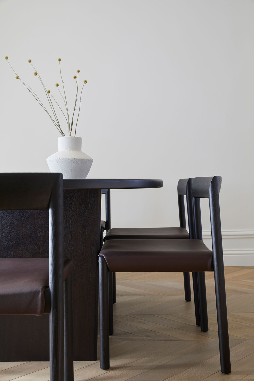 Dark dining table and chairs on wooden floor