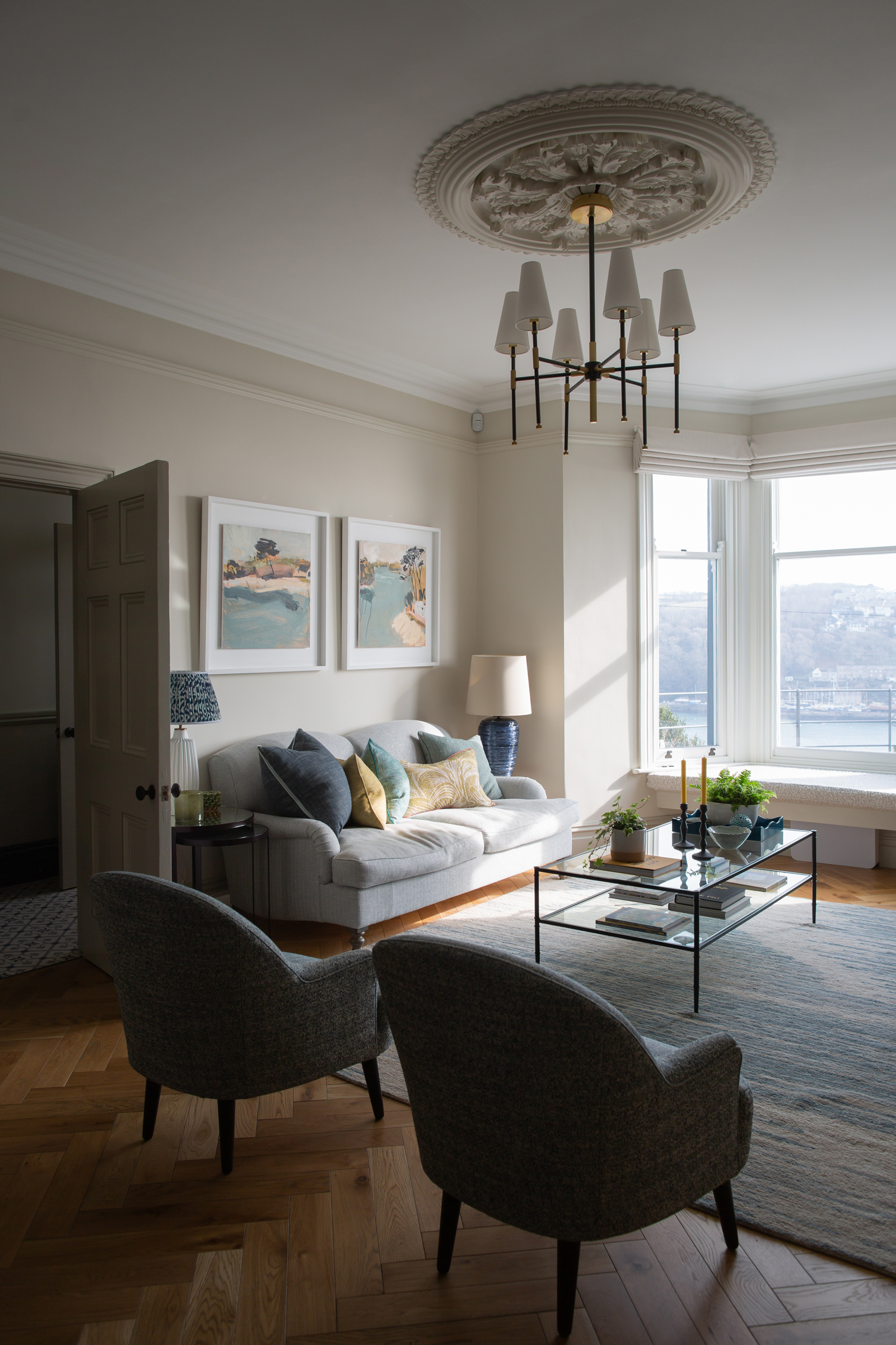Light-filled living room within a Victorian townhouse, combining restored period features with contemporary interior architecture as part of a thoughtful residential refurbishment for modern family living.
