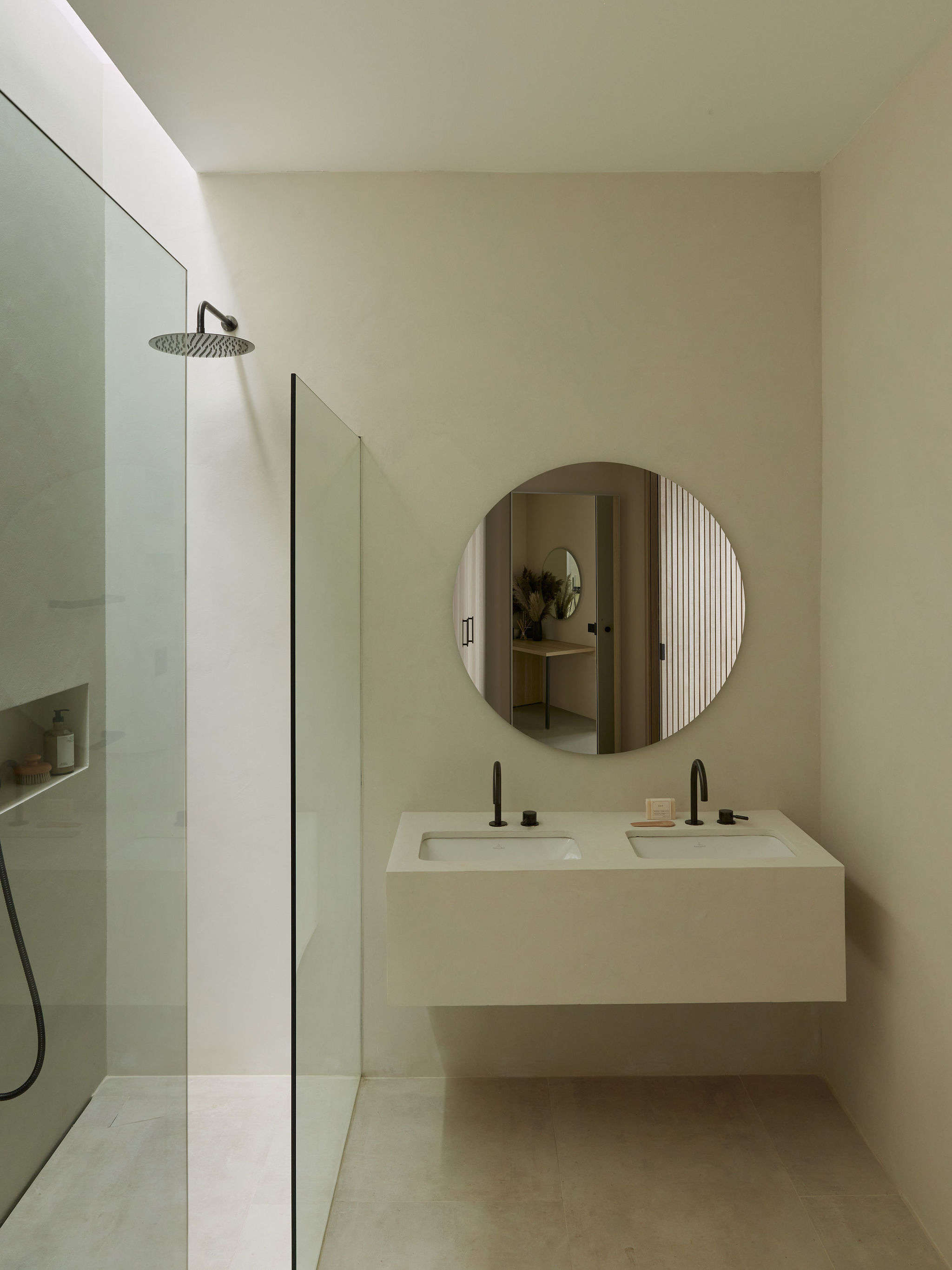 Sink in bathroom with round mirror