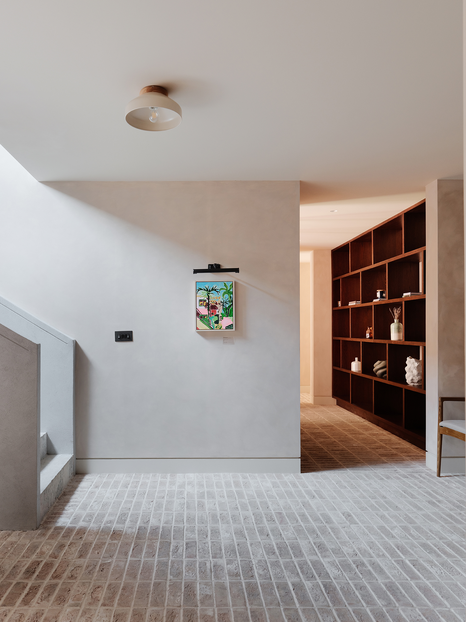 Brick Slip Flooring and a clean concrete staircase and neutral walls